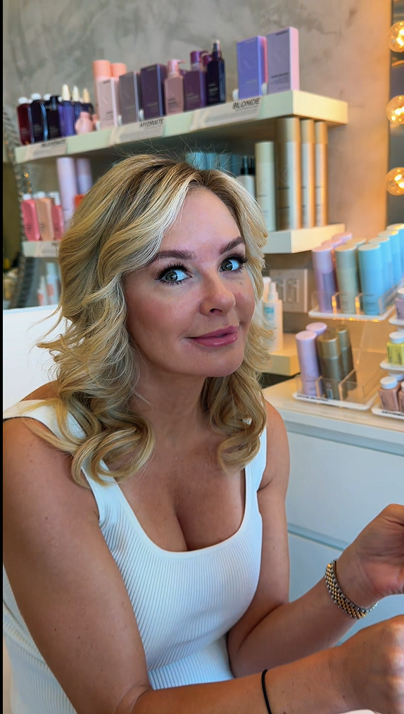 Client with styled blonde curls and natural makeup at Roza Glam