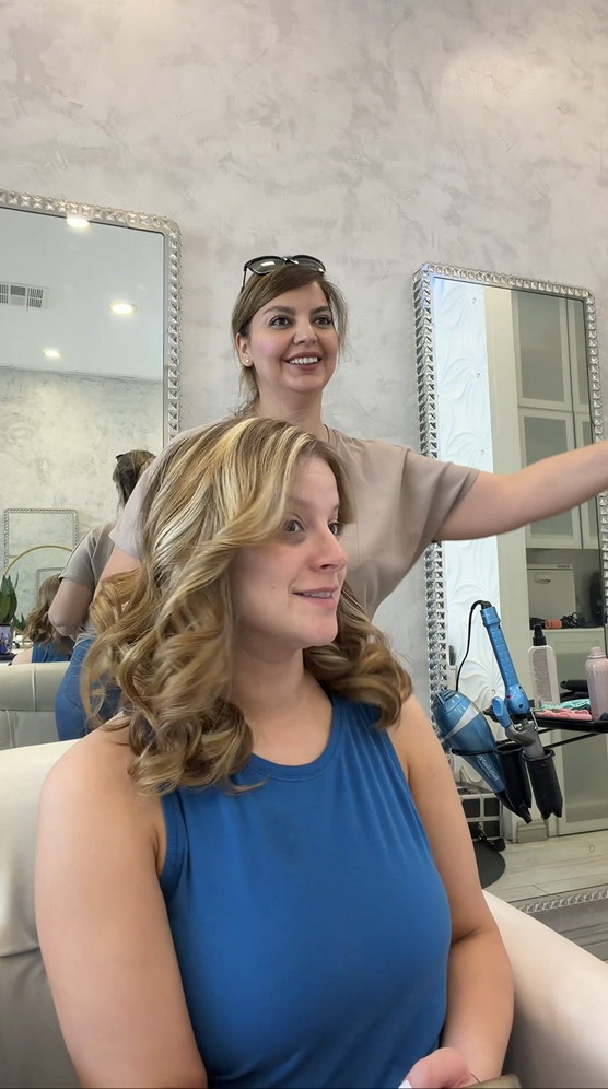 Blonde highlights with curled styling at Roza Glam