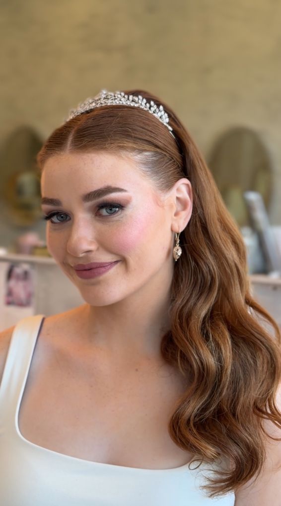Half-up styled waves with hair accessory at Roza Glam